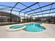 Backyard pool with a connected jacuzzi and screened enclosure for outdoor enjoyment at 2626 Calistoga Ave, Kissimmee, FL 34741