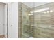 Bathroom featuring a frameless glass-enclosed shower with tiled walls and multiple shower heads at 2626 Calistoga Ave, Kissimmee, FL 34741