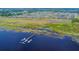 Community aerial view showcases a long pier with boat slips extending into a serene lake at 2706 Vermillion Ct, St Cloud, FL 34771