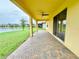 A covered back patio features a brick ground, ceiling fan, and views of the lake at 2706 Vermillion Ct, St Cloud, FL 34771