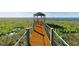 A wooden walkway with metal railings leading to a gazebo at the end of the pier at 2706 Vermillion Ct, St Cloud, FL 34771