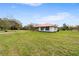 Charming single-story home with a red roof, complemented by a well-manicured lawn and lush greenery at 2730 W Highland St, Lakeland, FL 33815