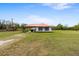 Exterior front view shows a ranch home with a red roof and a large front yard at 2730 W Highland St, Lakeland, FL 33815