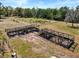 Property showcases wooden structures, set against a verdant landscape under a clear sky at 2730 W Highland St, Lakeland, FL 33815