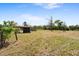 Overhead shot shows buildings with an open yard and a barbed-wire fence at 2730 W Highland St, Lakeland, FL 33815