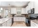 Modern kitchen with white cabinetry, stainless steel appliances, and light countertops at 2929 Satire St, Kissimmee, FL 34746