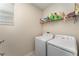 Functional laundry room with modern washer and dryer, storage space, and ample lighting at 2929 Satire St, Kissimmee, FL 34746