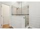 Modern bathroom with glass shower, white shiplap, and neutral tile at 2958 Willow Bay Ter, Casselberry, FL 32707