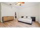 Bright bedroom featuring light wood floors, ceiling fan, and a modern dresser at 2958 Willow Bay Ter, Casselberry, FL 32707