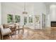 Cozy dining nook with views of pool, featuring travertine floors and stylish chandelier at 2958 Willow Bay Ter, Casselberry, FL 32707