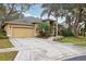 Spacious driveway and attached two-car garage of a well-maintained home surrounded by trees at 2958 Willow Bay Ter, Casselberry, FL 32707