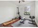 Home gym with rower, weight bench, and hardwood flooring overlooking lush greenery at 2958 Willow Bay Ter, Casselberry, FL 32707