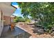 Back patio with adjacent planting beds and view of backyard and screened in pool at 30 Cornwall Ct, Casselberry, FL 32707