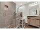 Modern bathroom featuring a glass-enclosed shower with bench, neutral gray tiling and wood-look flooring at 30 Cornwall Ct, Casselberry, FL 32707