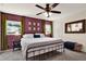 Cozy bedroom with a comfortable king-size bed, ceiling fan, and natural light from the windows at 30 Cornwall Ct, Casselberry, FL 32707