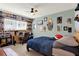 Playful bedroom featuring blue bedding, quirky decor and display shelves with pop culture items at 30 Cornwall Ct, Casselberry, FL 32707