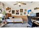 Cozy bedroom with gray carpet, neutral walls, unique artwork, and desk area at 30 Cornwall Ct, Casselberry, FL 32707