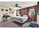 Stylish bedroom with a king-size bed, plum accent wall, ceiling fan, and neutral decor at 30 Cornwall Ct, Casselberry, FL 32707