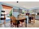 Bright dining area with gray cabinets, stylish table and chairs, and large window overlooking the backyard at 30 Cornwall Ct, Casselberry, FL 32707