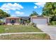 Charming single-story home with a two-car garage, solar panels, and a well-manicured lawn at 30 Cornwall Ct, Casselberry, FL 32707