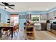 Open kitchen and dining space with gray cabinetry and a dining table with seating for four at 30 Cornwall Ct, Casselberry, FL 32707