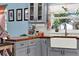 Charming kitchen featuring gray cabinetry, a farmhouse sink, and butcher block countertops at 30 Cornwall Ct, Casselberry, FL 32707