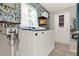 Bright laundry room with large washer and dryer and designer wallpaper at 30 Cornwall Ct, Casselberry, FL 32707