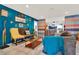 Bright and stylish living room with tile floors, blue accent wall, and eclectic decor at 30 Cornwall Ct, Casselberry, FL 32707