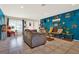 Open-concept living room with tile flooring, bright blue walls, and abundant natural light at 30 Cornwall Ct, Casselberry, FL 32707