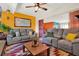 Cozy living room featuring a large sectional sofa, colorful walls, and unique area rug at 30 Cornwall Ct, Casselberry, FL 32707