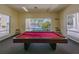 Billiards room featuring a red felt pool table and a view of the community pool at 3162 Sun Lake Ct # B, Kissimmee, FL 34747