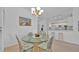 Bright dining area with glass table, wicker chairs, and view to a white kitchen at 3162 Sun Lake Ct # B, Kissimmee, FL 34747