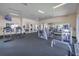 Well-equipped fitness center with treadmills, elliptical machines, weights, and wall-mounted mirrors at 3162 Sun Lake Ct # B, Kissimmee, FL 34747