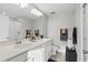 Modern bathroom featuring double sinks, quartz countertops, and a glass-enclosed shower at 319 Smugglers Way, Apopka, FL 32712