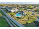 Aerial view of community pool and lounge area. Pool features palm trees and manicured landscape at 319 Smugglers Way, Apopka, FL 32712