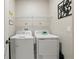 Functional laundry room with modern washer and dryer units and minimalist decor at 319 Smugglers Way, Apopka, FL 32712