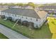 Aerial view of the rear of the townhomes, featuring a well maintained lawn and fenced in yard at 319 Smugglers Way, Apopka, FL 32712