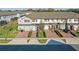 Street view of townhomes highlighting red shutters, red doors, and beautifully maintained landscaping at 319 Smugglers Way, Apopka, FL 32712