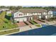 Street view showcasing the townhomes, including red brick driveways and maintained landscaping at 319 Smugglers Way, Apopka, FL 32712