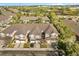 An aerial view of townhomes surrounded by lush trees and greenery in a well-maintained community at 409 Hilgard Cv # 106, Sanford, FL 32771