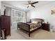 Bright bedroom with a ceiling fan, a large window and a wood-framed bed at 409 Hilgard Cv # 106, Sanford, FL 32771