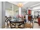 Bright breakfast nook with a glass-top table and sliding glass doors to the exterior at 409 Hilgard Cv # 106, Sanford, FL 32771