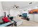 Bright living room with neutral carpet, view to the kitchen, and ceiling fan at 409 Hilgard Cv # 106, Sanford, FL 32771