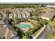 An aerial shot of a pool surrounded by manicured landscaping and a beautiful neighborhood at 409 Hilgard Cv # 106, Sanford, FL 32771