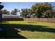 A large, grassy backyard enclosed by a tall wooden fence, with ample space for recreation at 4452 Fairview Ave, Orlando, FL 32804