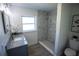 Modern bathroom with a tiled walk-in shower, vanity, mirror, and ample natural light at 4452 Fairview Ave, Orlando, FL 32804