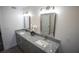 Bright bathroom featuring a double vanity with gray cabinets and granite countertops at 4452 Fairview Ave, Orlando, FL 32804