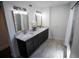 Bathroom with double vanity, marble countertop, and elegant lighting fixtures at 4452 Fairview Ave, Orlando, FL 32804