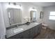 Bathroom with a double vanity, gray cabinets, and modern light fixtures at 4452 Fairview Ave, Orlando, FL 32804