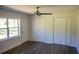 Bright bedroom with wood flooring and a ceiling fan with two large closets flanking the door at 4452 Fairview Ave, Orlando, FL 32804